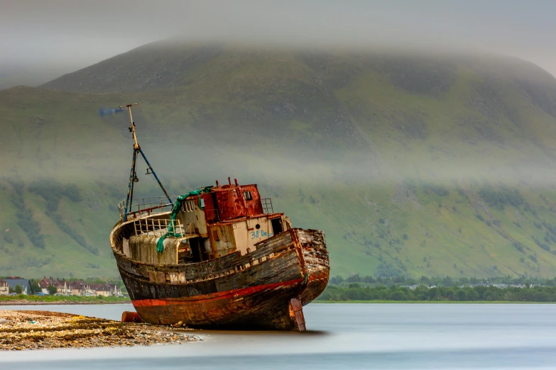 a dilapidated ship in the middle of a body of water