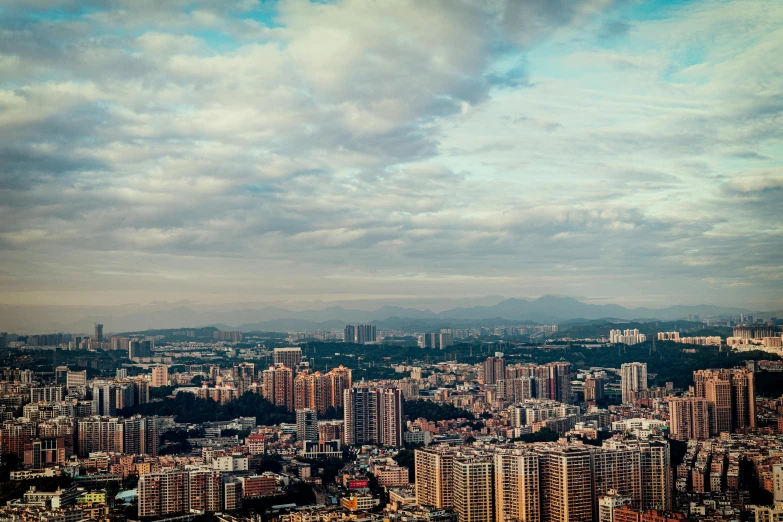 large city with several high rise buildings under a cloudy sky