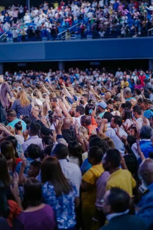 a large crowd gathered at a convention in the sun