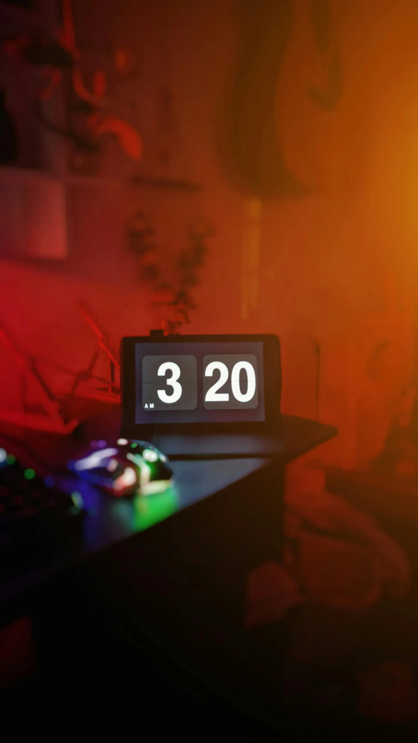 a small black clock sitting on top of a table