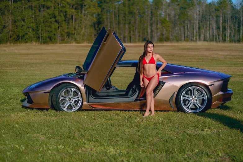 a young woman in a bikini stands next to a sports car