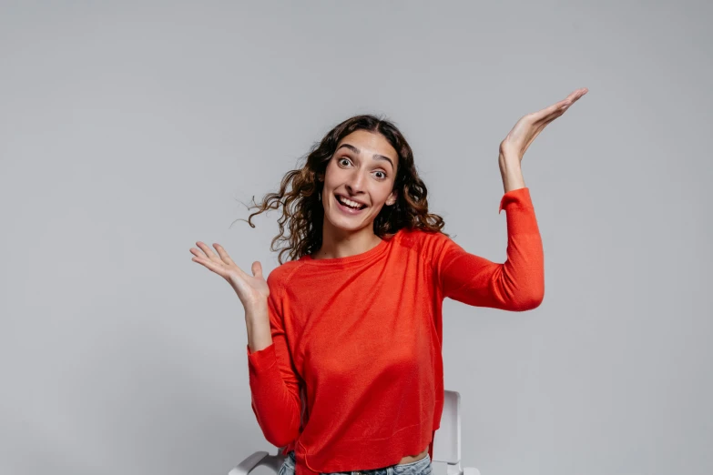 a woman that is standing on a chair