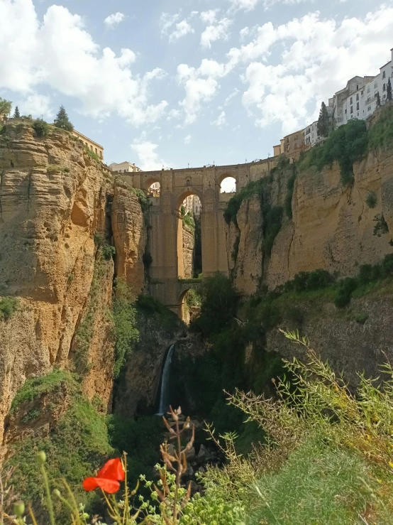 a view of a waterfall flowing under the bridge