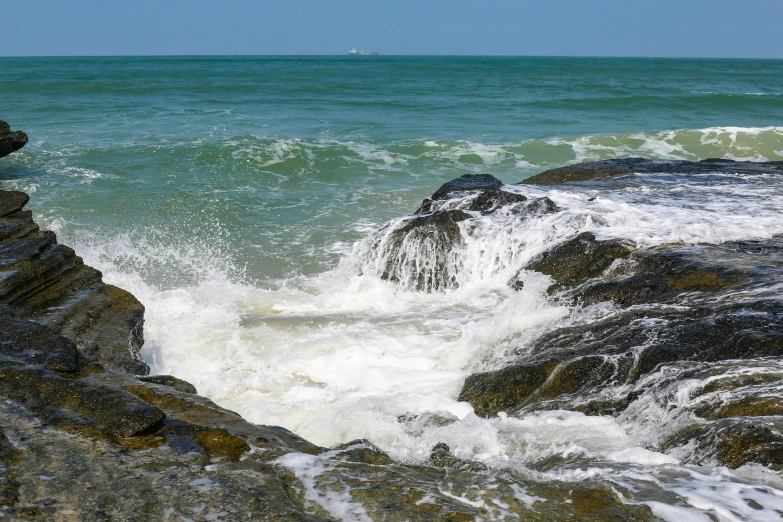 a rock with sea water behind it