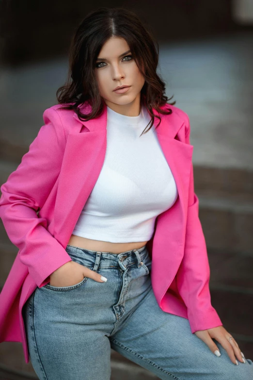 a woman in a white top and blue jeans posing