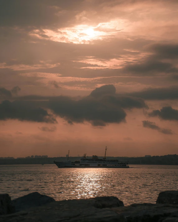 a cruise ship in the distance off the coast of a body of water