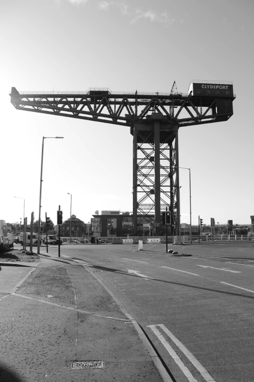 a large bridge spanning over a road near a city