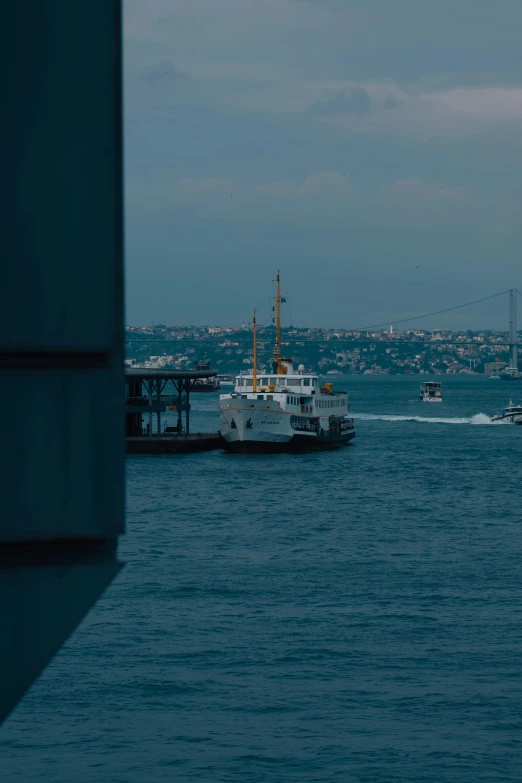 a boat is sailing on the ocean towards a large body of water