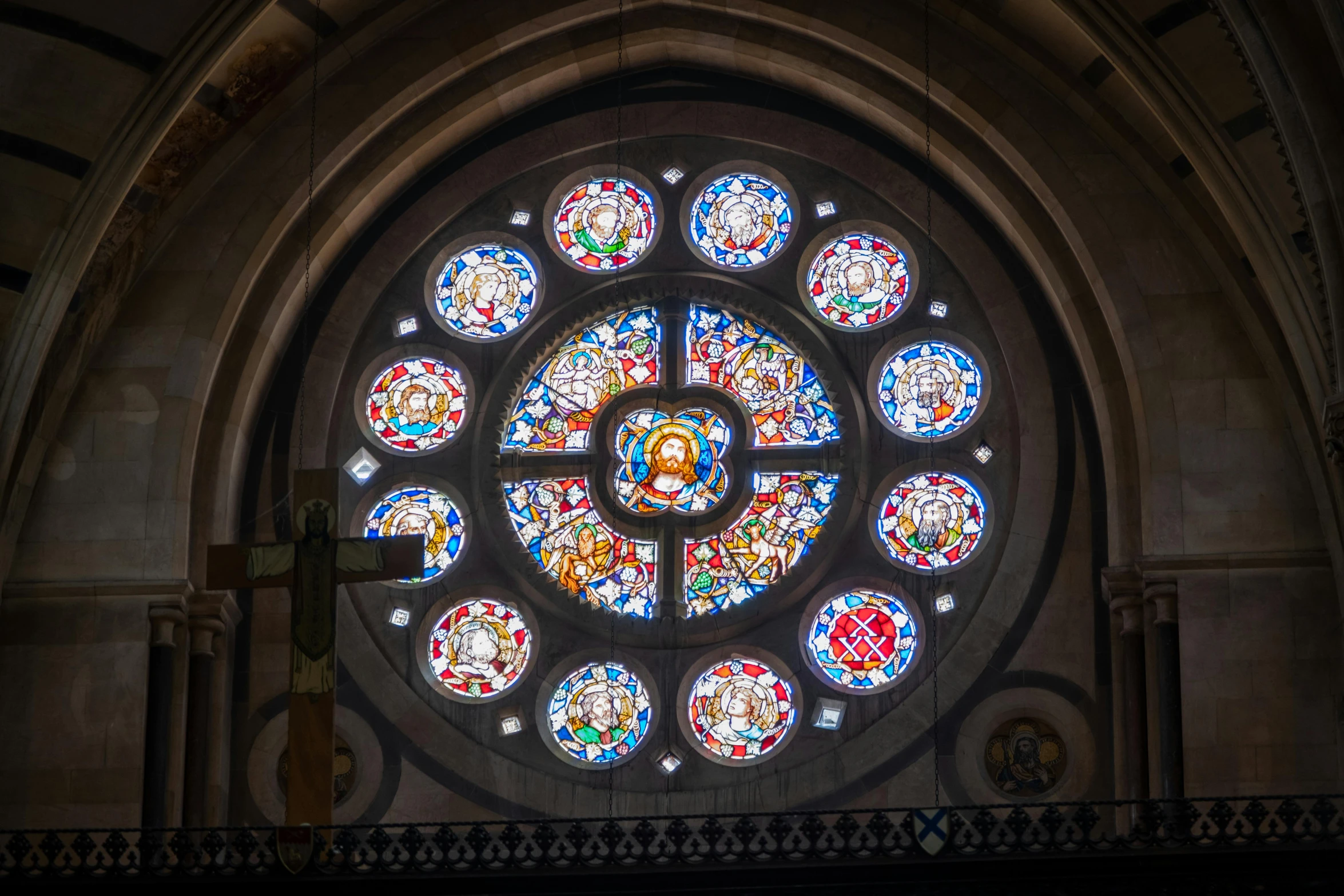 an oval stain glass window is shown in the church