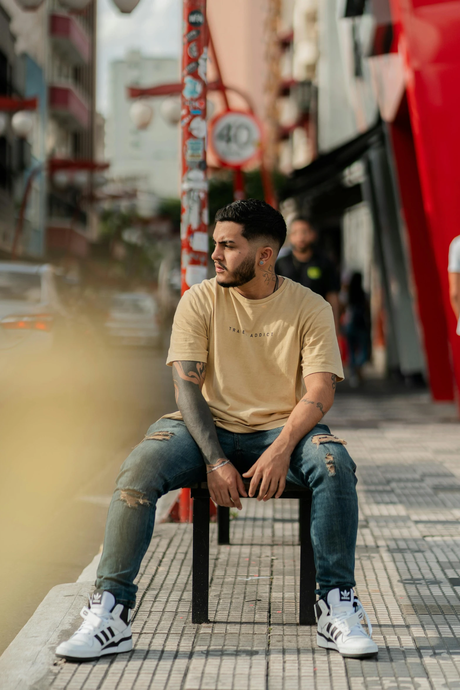 a man sitting on a bench in front of stores