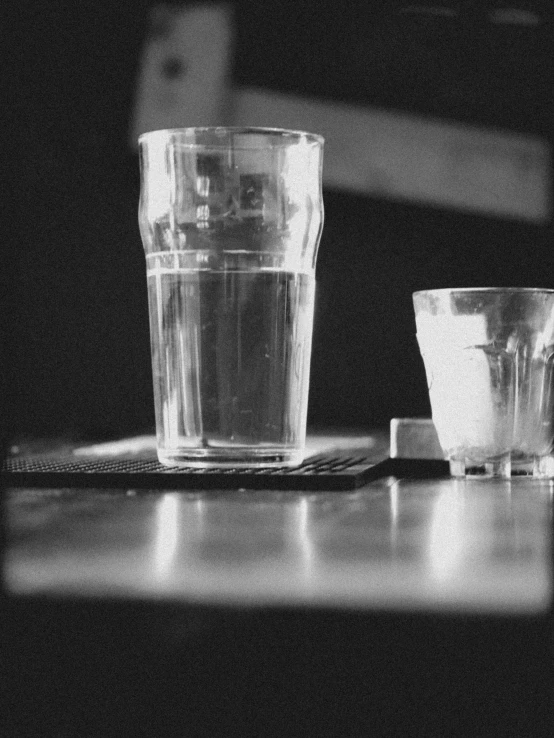 two empty cups are on a table with a laptop