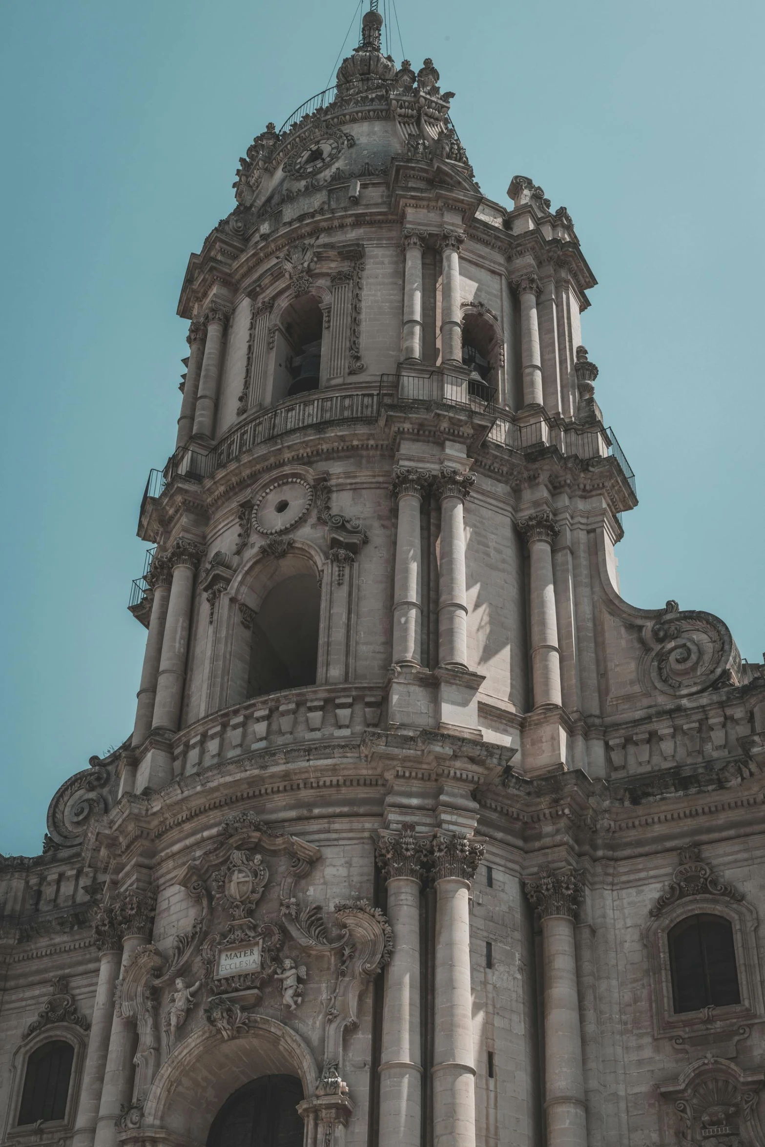 the large clock tower on the front of a cathedral