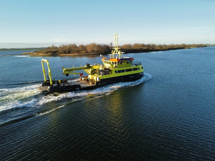 the boat is going along the water near land