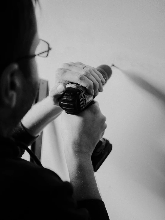 a man is holding a tooth brush and looking down