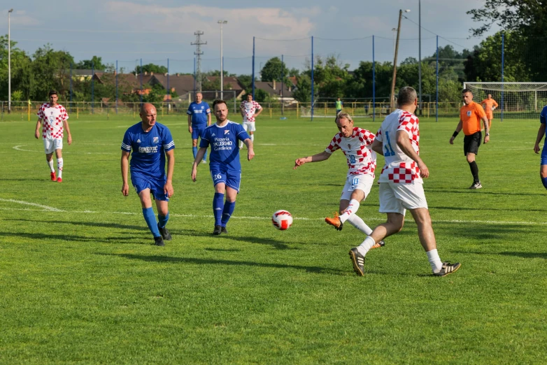 soccer game being played with players playing a game on grass