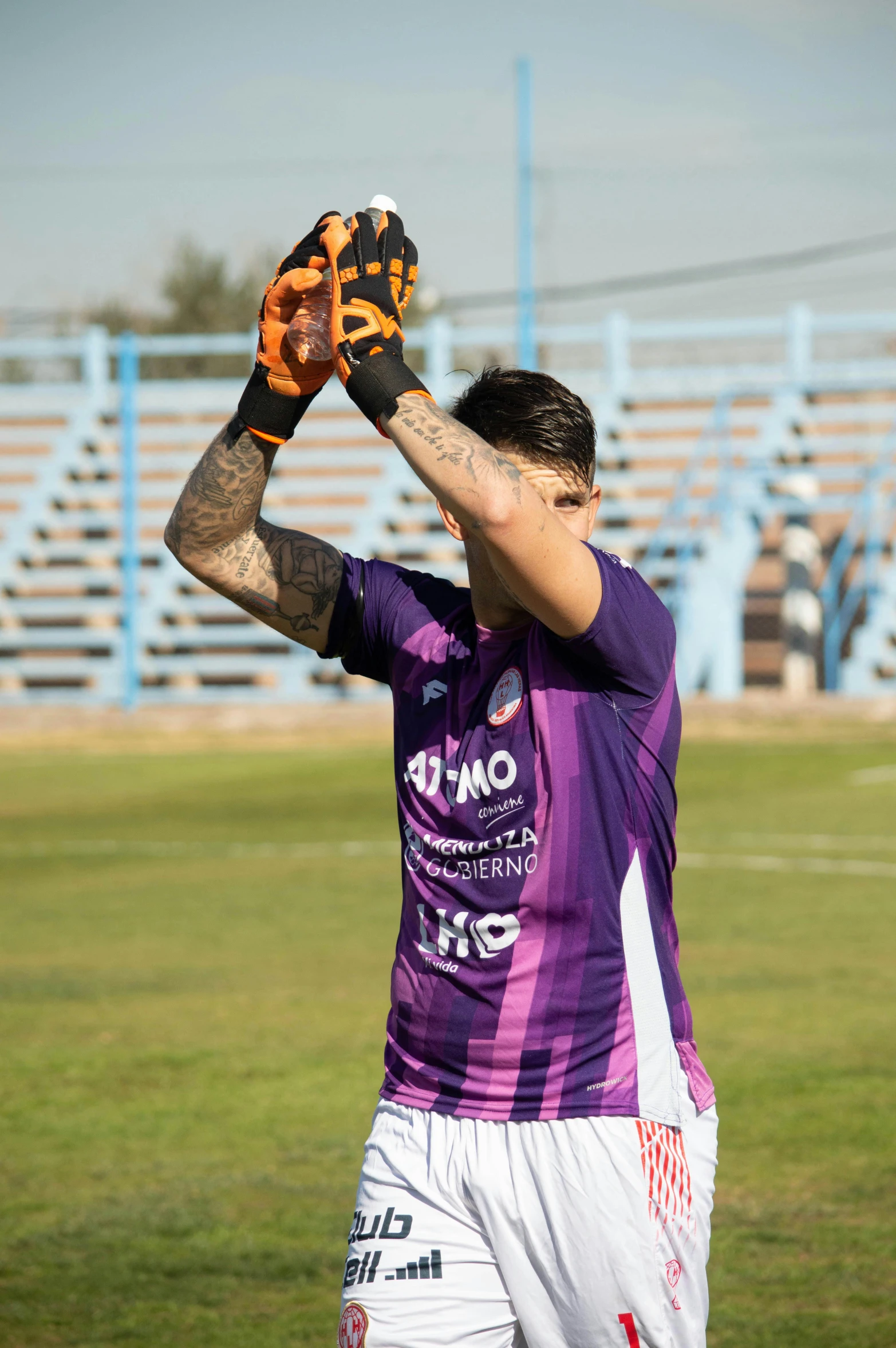 a soccer player saluting the fans during their game