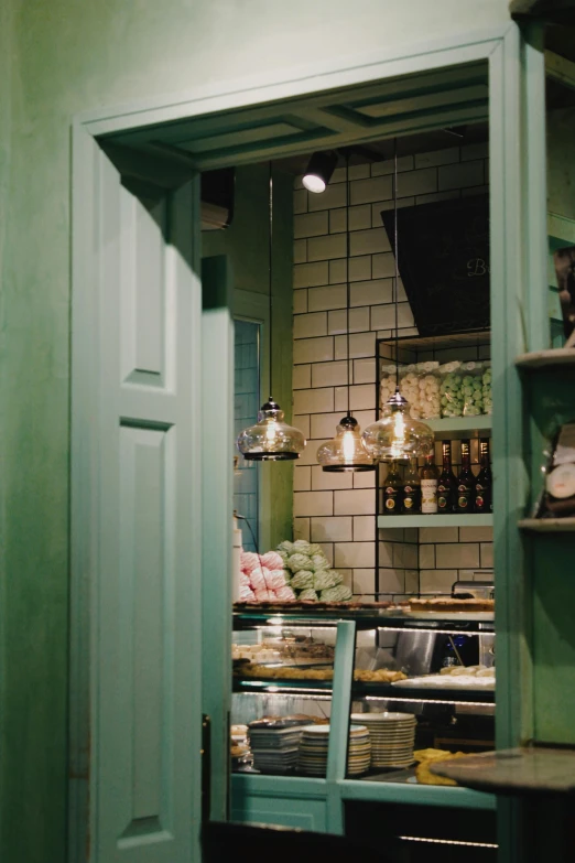 a green door and windows in a shop