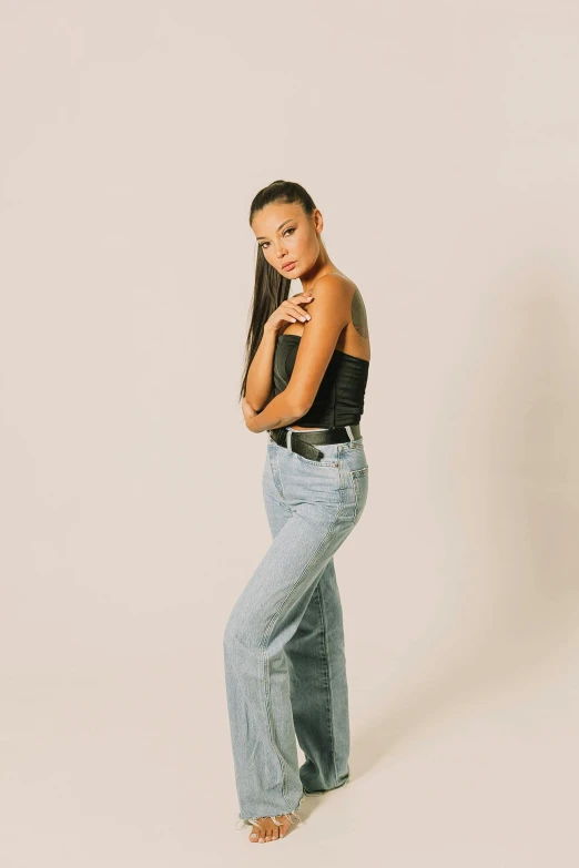 a woman with long brown hair and black top posing