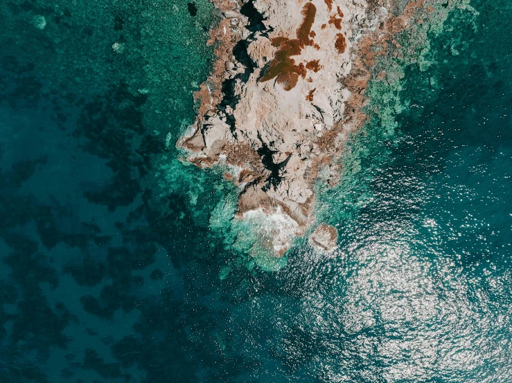 water flowing towards a large rock and land