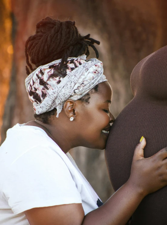 a woman is kissing someone on the lips