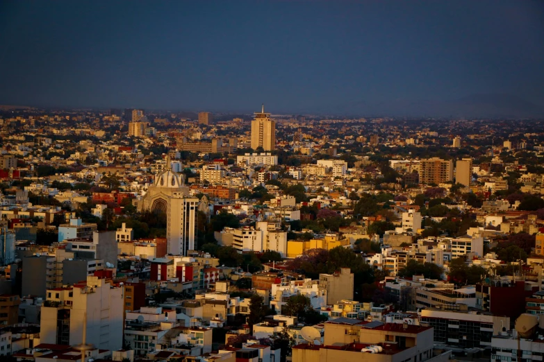 a city skyline in the evening from an upward view