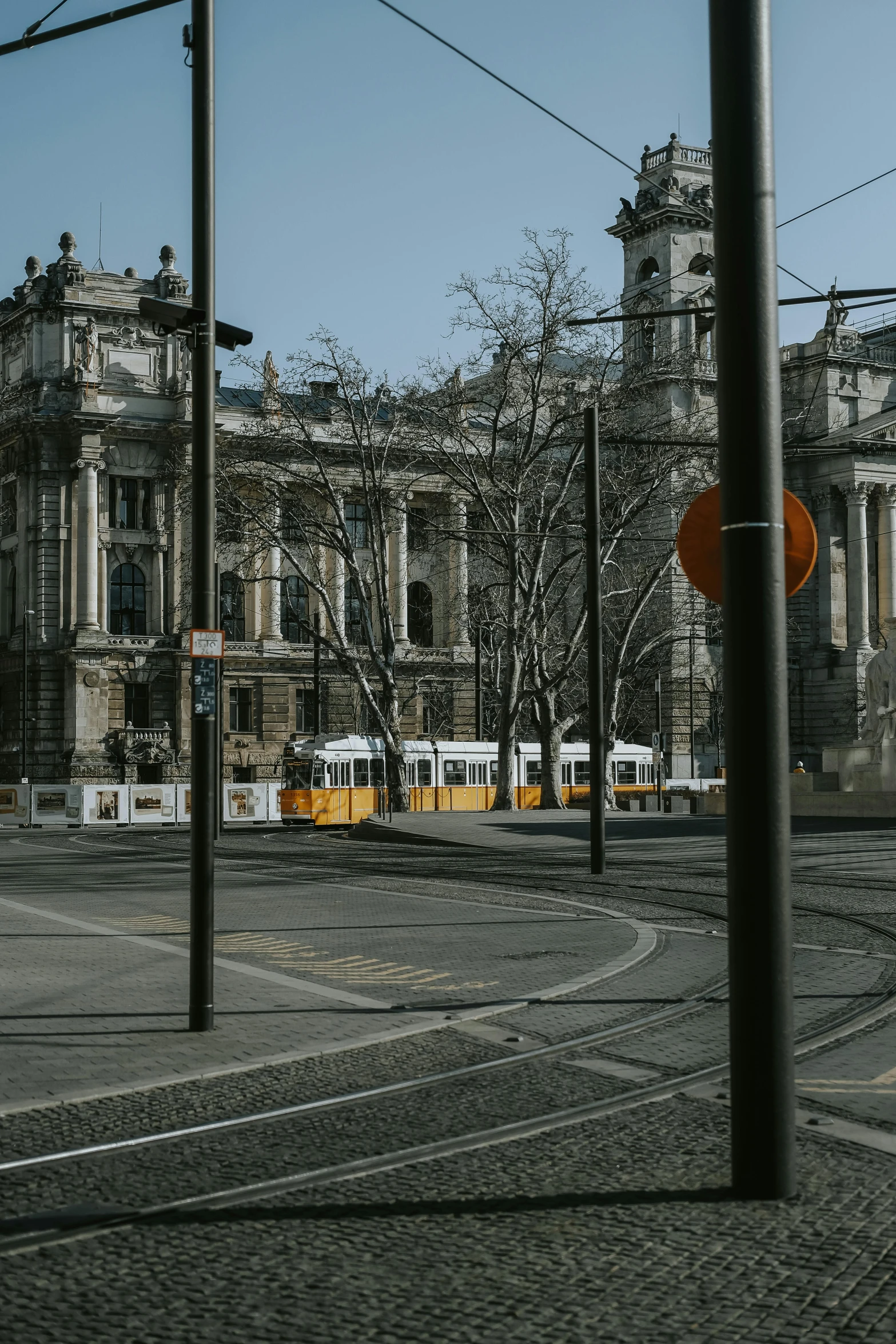 street intersection with trolleys and large buildings