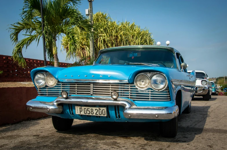 an old car is parked next to other classic cars