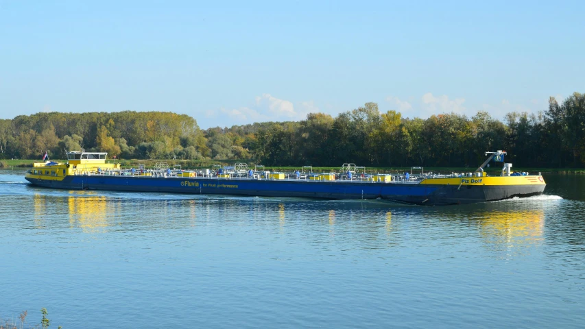 a large yellow and blue boat with people riding on it