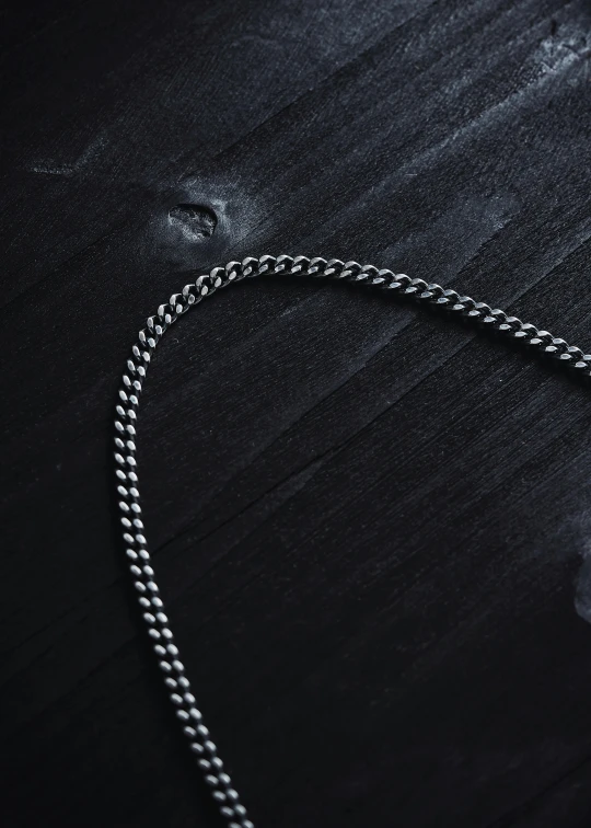 a necklace with two balls is laying on a table