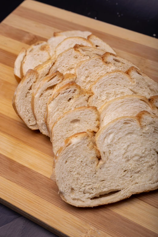 several slices of bread on top of a wooden board