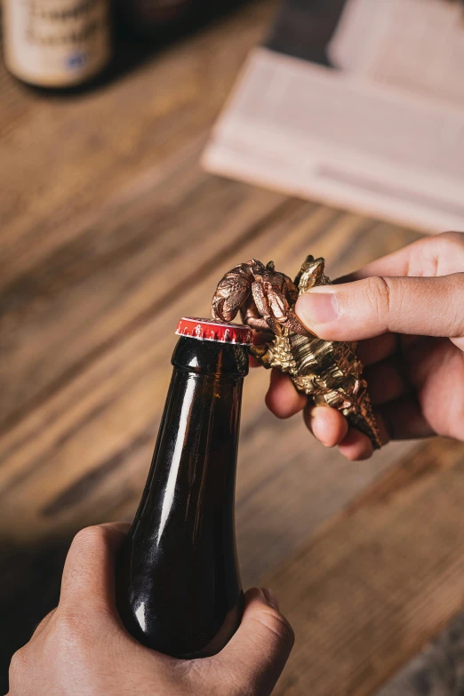 someone holding a beer with gold ribbons on it