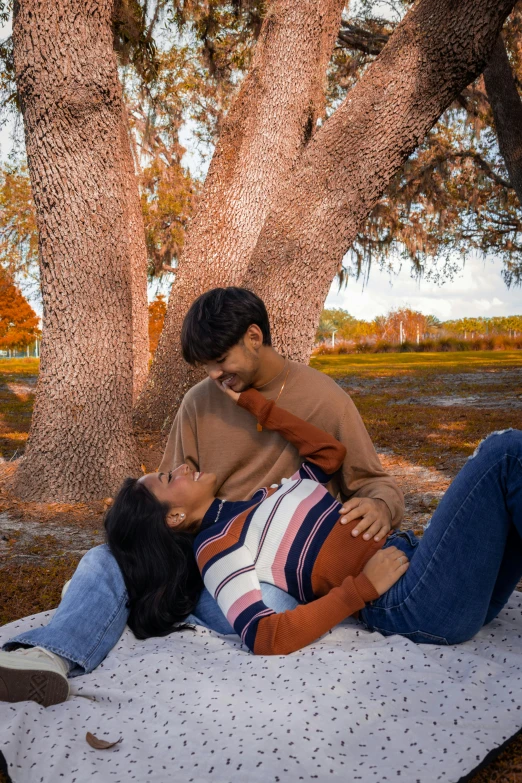 a man holding a woman on top of a mattress