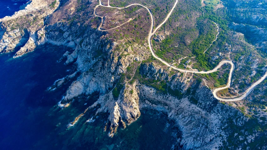 a road going through a mountain on a clear day