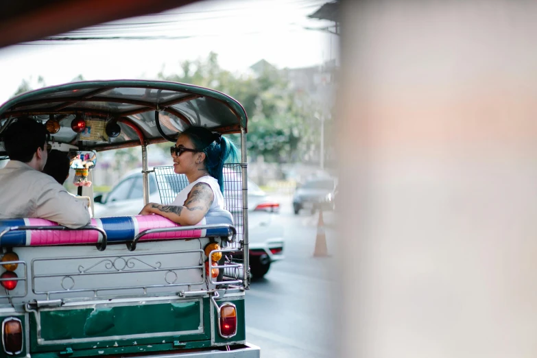 a man and woman driving an auto - rickshaw in a city