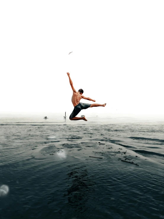 a man leaping in the air in the water