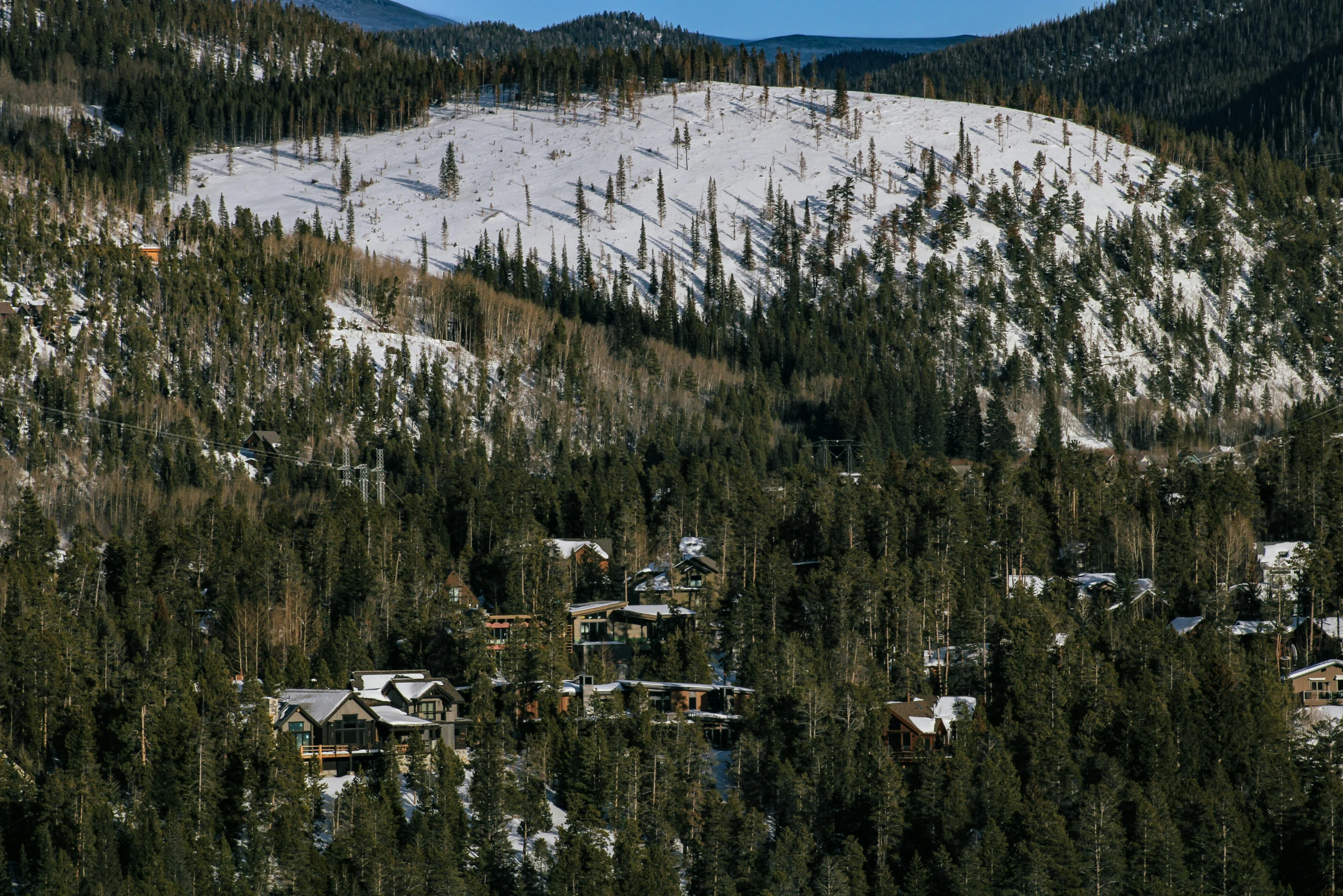 this is the view looking down at a snow covered mountain