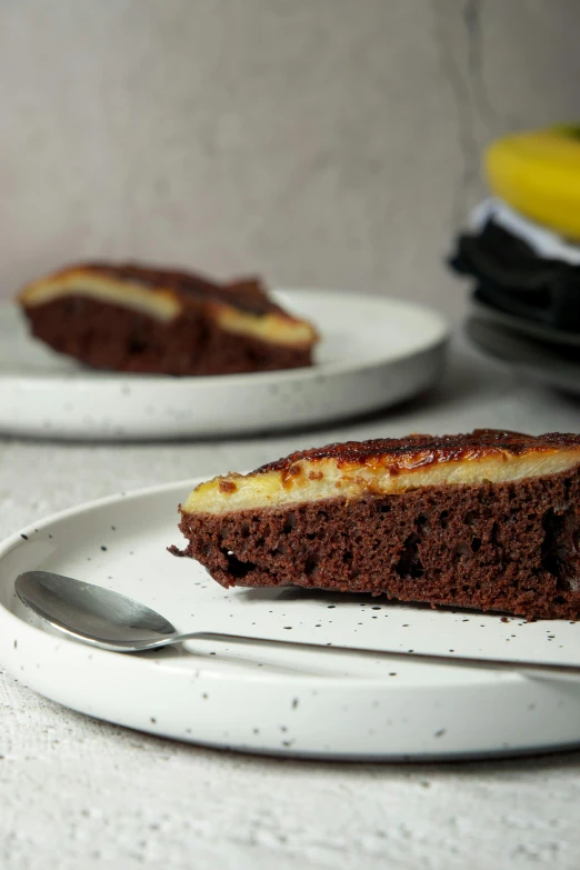 a slice of cake on a plate with a spoon next to it