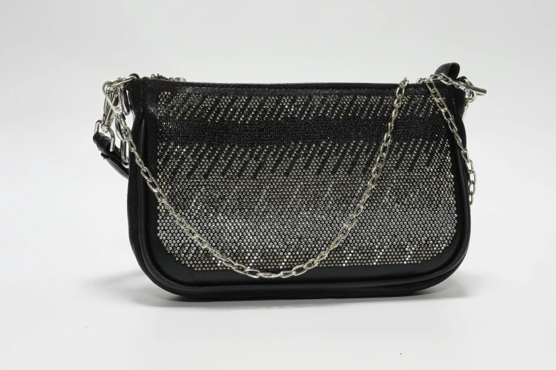black purse that is black and white with gold hardware