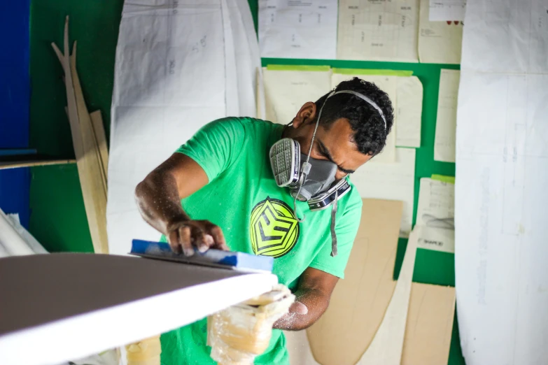 a man wearing a mask with some wood carving tools