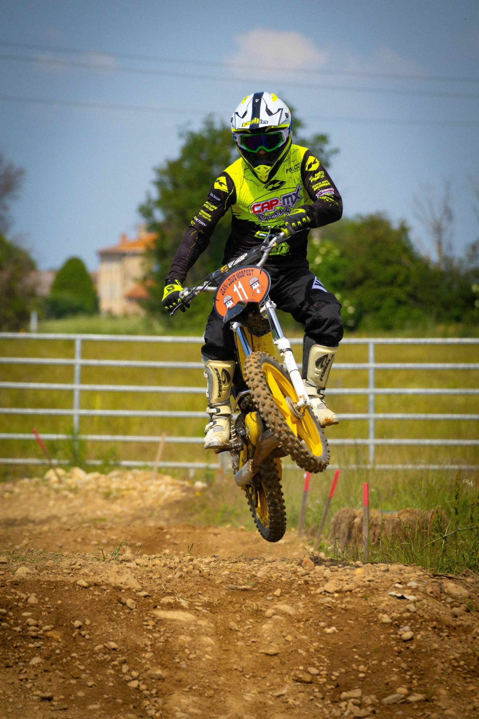 a person on a dirt bike in midair over a hill