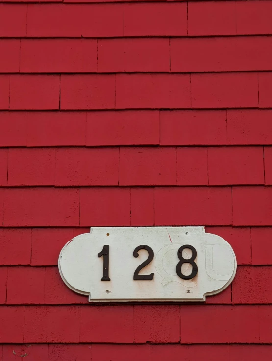 a red building with a number sign on the front of it