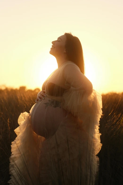 a woman who is sitting down in a field