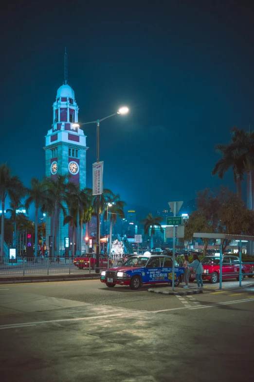 a traffic light with cars parked on the side