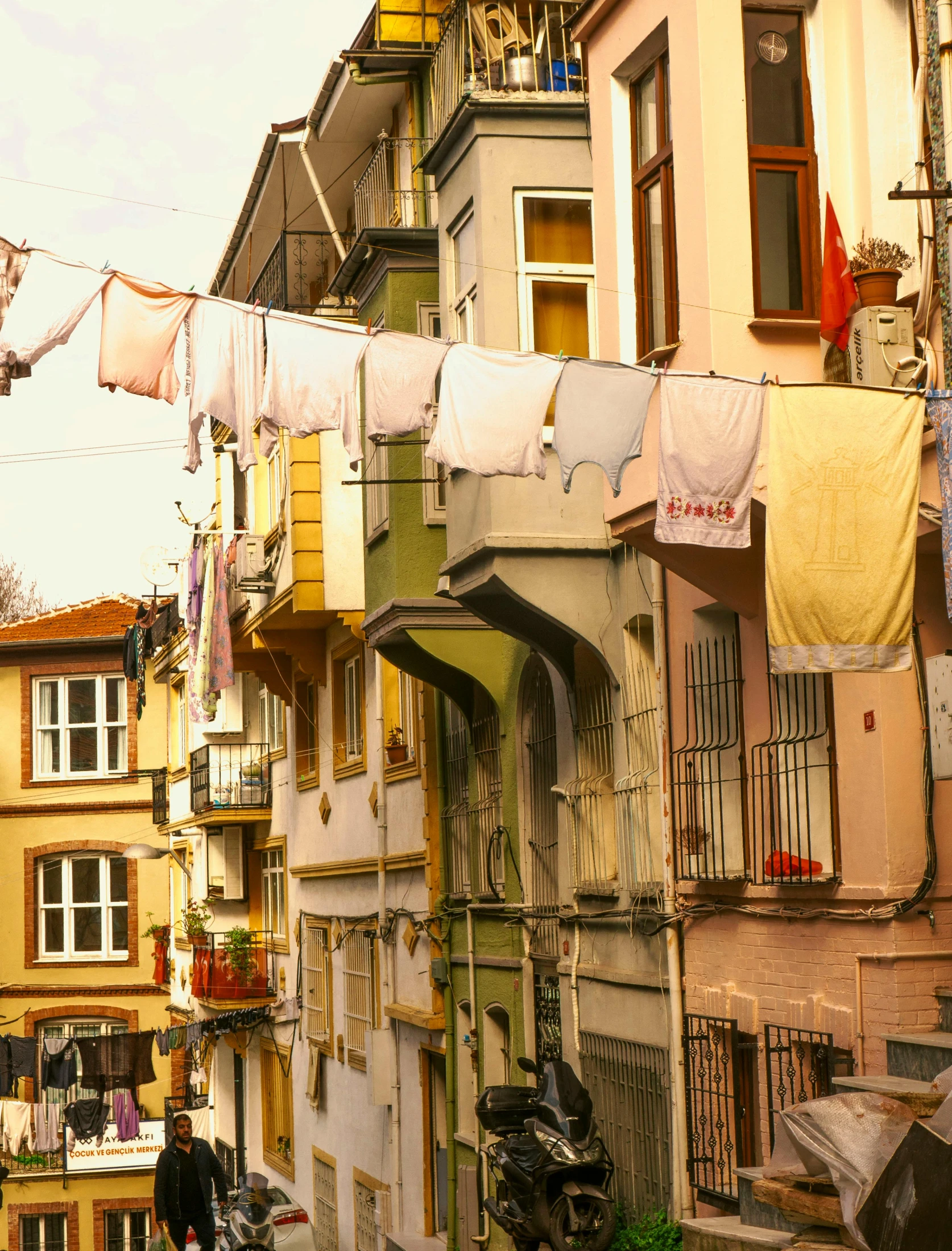 multiple multi - colored apartment buildings with clothes hanging off the washing lines