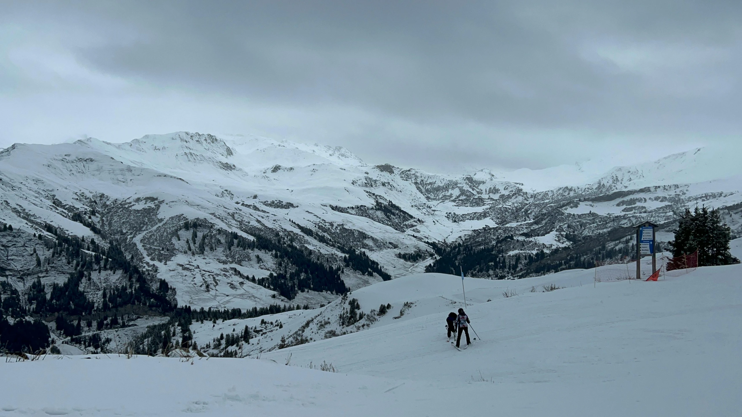 skiers are trekking down a snow - covered mountain