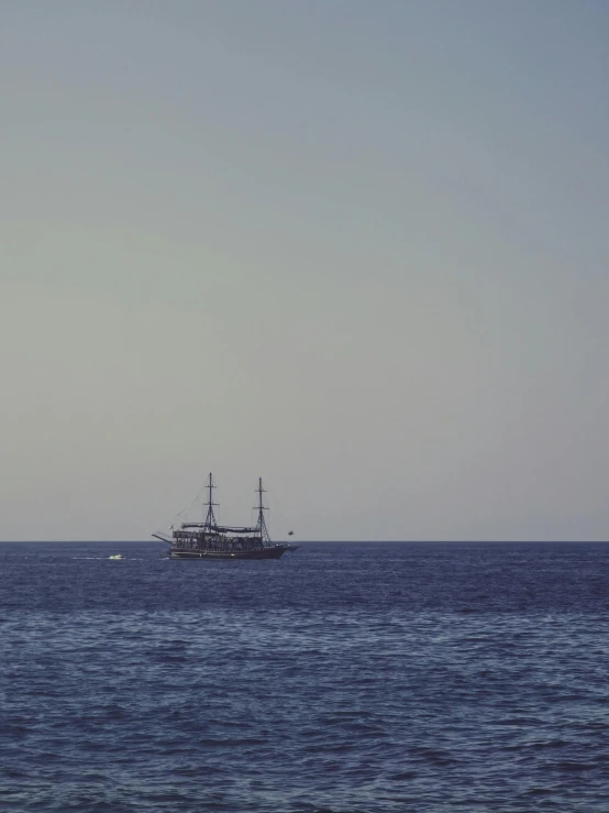 the boat is in the water near some rocks