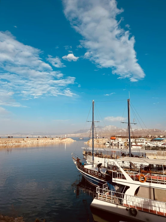 several boats are docked in the water of a marina