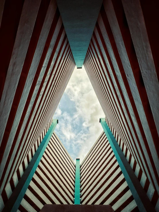 the roof of a large building with some poles