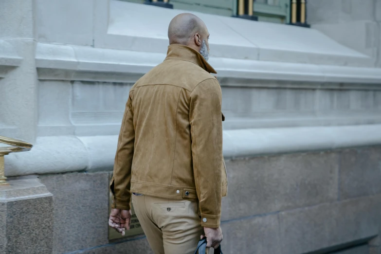 a man standing at the base of a stone pillar