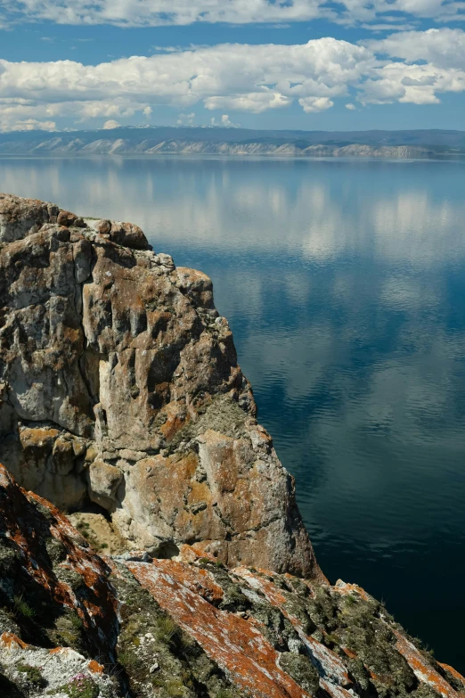 a rocky coast that is in the middle of a lake